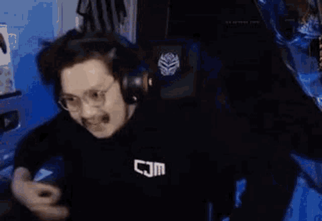 a man with glasses and a mustache is making a funny face while sitting in a chair .