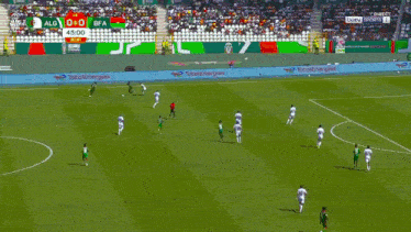 a soccer player is kneeling down in front of a net with a score of 0 to 0