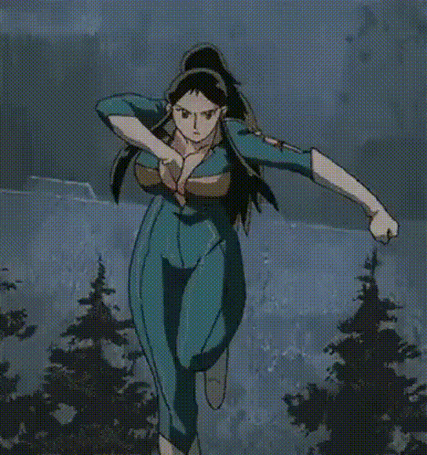 a woman in a blue jumpsuit is running in a forest with trees in the background .