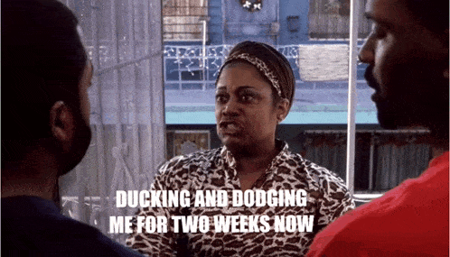 a woman in a leopard print shirt is talking to two men with the caption ducking and dodging me for two weeks now