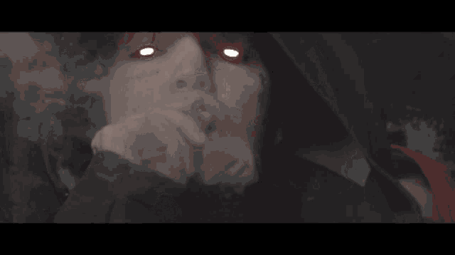a close up of a person smoking with smoke coming out of their mouth
