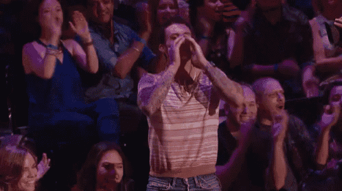 a man in a crowd with gwen written on his face