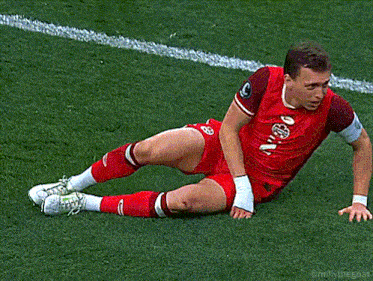a soccer player in a red jersey with the number 1 on it is laying on the ground