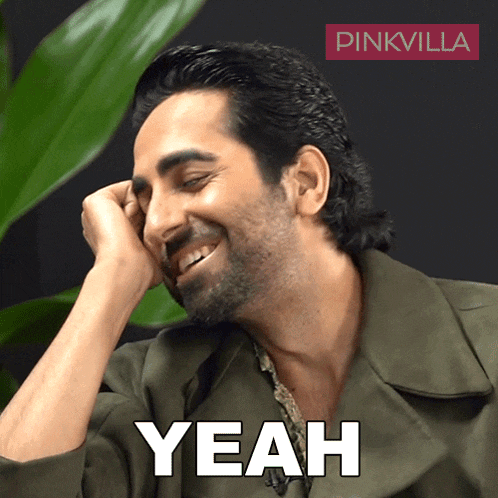 a man with a beard is smiling and the word yeah is on the screen