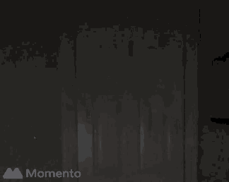 a dark room with the word momento on the bottom right
