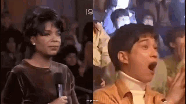 a woman is holding a microphone in front of a crowd while a boy is holding his mouth open .