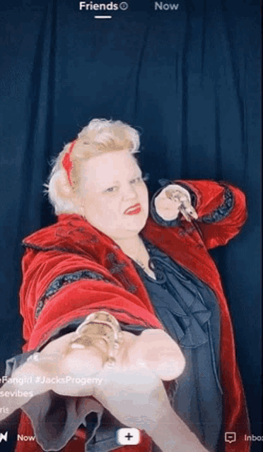 a woman in a red coat is holding something in her hand with the words " friends " below her