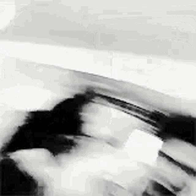 it is a black and white photo of a person holding a gun .
