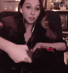 a woman wearing headphones is playing a game