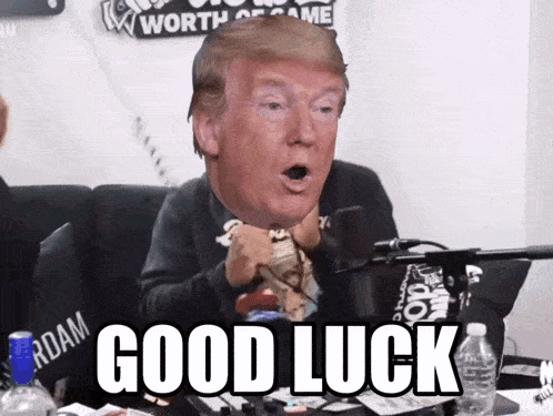 donald trump sitting in front of a microphone with the words " good luck " below him