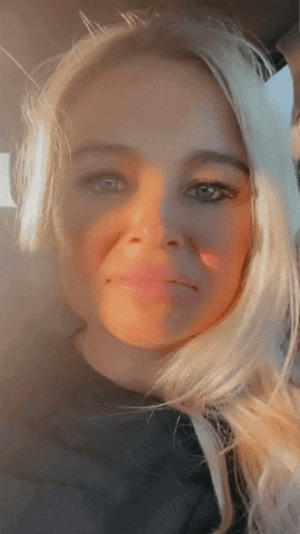 a close up of a blonde woman 's face with a nose ring