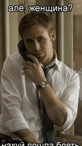 a man in a white shirt and tie is talking on a phone in a foreign language