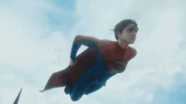 a man in a superman costume is flying over a jet