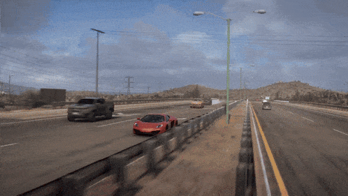 a red car is driving down a highway with a sign that says ' a ' on it