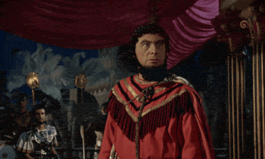 a man in a roman costume is sitting in a room with columns and says " as developers "