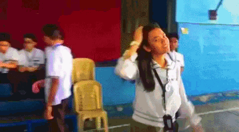a girl is standing in front of a group of children
