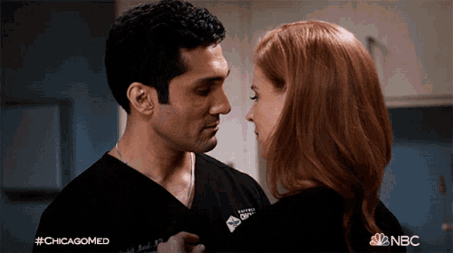 a man and a woman are looking into each other 's eyes with #chicagomed on the bottom right