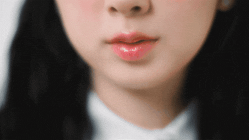 a close up of a woman 's lips with a white shirt