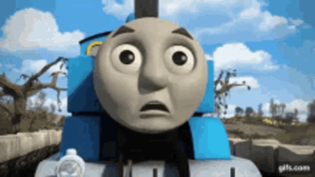 a thomas the train with a surprised look on his face .