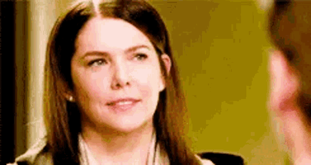 a woman is looking at a man while talking to him .