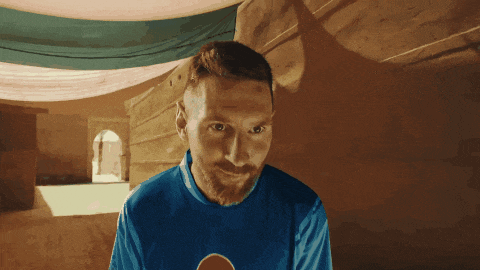a man with a beard wears a blue shirt with a pepsi logo on it