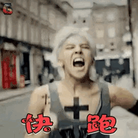 a man in a tank top with a cross on his chest is screaming in chinese