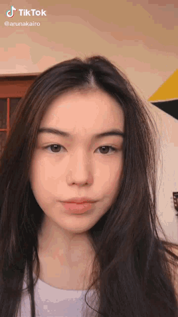 a close up of a girl 's face with a tiktok watermark