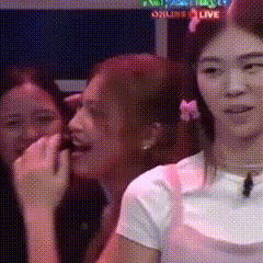 a group of women are sitting in front of a sign that says online live on it