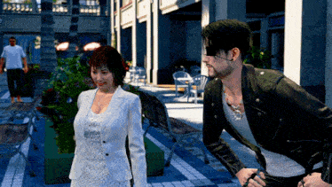 a man in a leather jacket stands next to a woman in a white dress