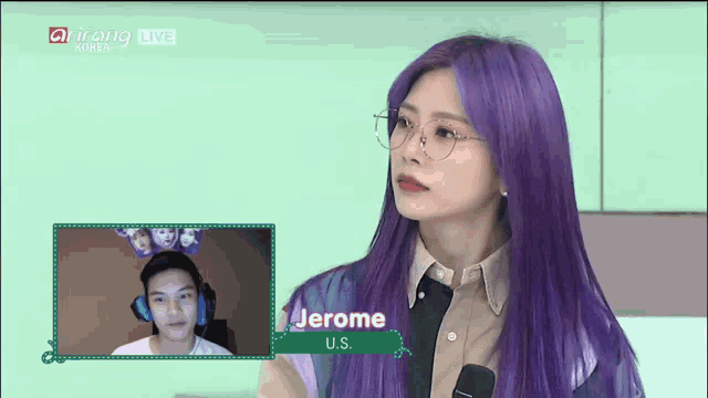 a woman with purple hair and glasses talks to a man named jerome