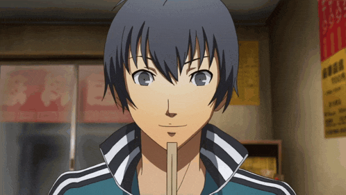 a man in a blue and white adidas jacket is eating ramen
