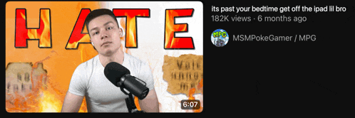 a man stands in front of a microphone with the word hate in red