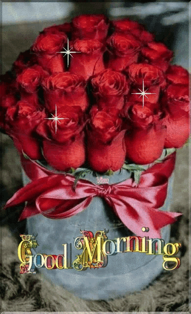 a bouquet of red roses with a red bow and the words good morning
