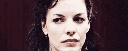 a close up of a woman 's face with a serious expression on her face .