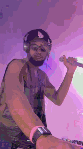 a man wearing headphones and a hat with the letter l on it