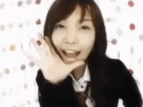 a woman in a school uniform and tie is making a funny face .