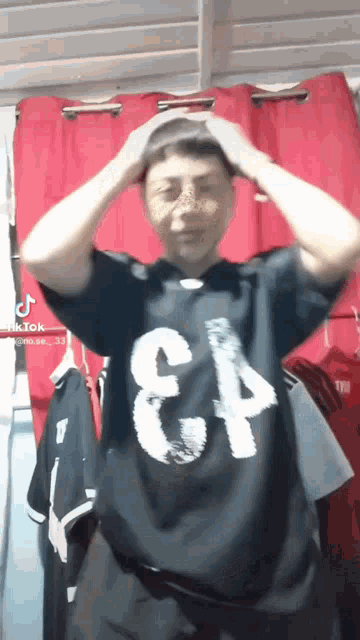 a man is wearing a black shirt with the number 34 on it