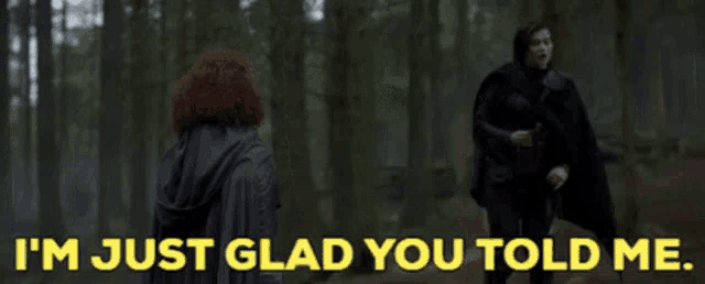 a man and a woman are standing in the woods and the man says i 'm just glad you told me ..