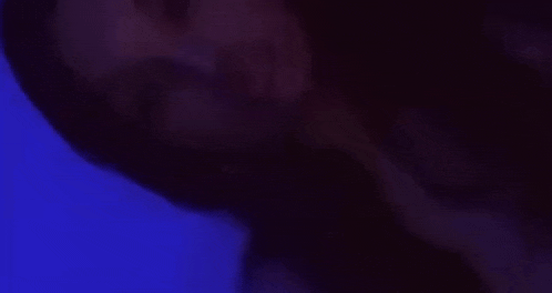 a close up of a person 's face with their eyes closed in a dark room .