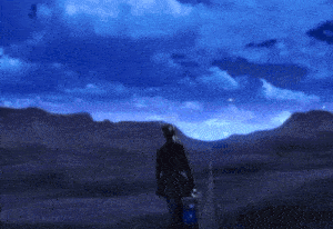 a person walking down a road with a suitcase in their hand