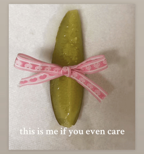 a pickle with a pink ribbon tied around it and the words this is me if you even care