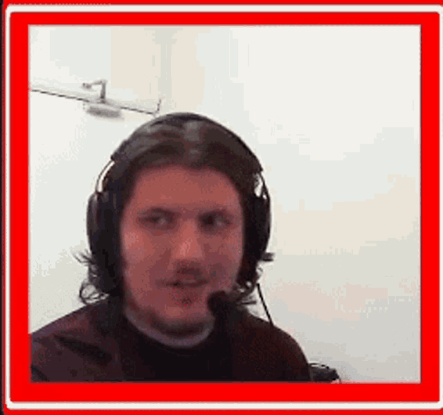 a man wearing headphones talking into a microphone