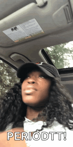 a woman in a hat is sitting in a car with the word periodtt on her face
