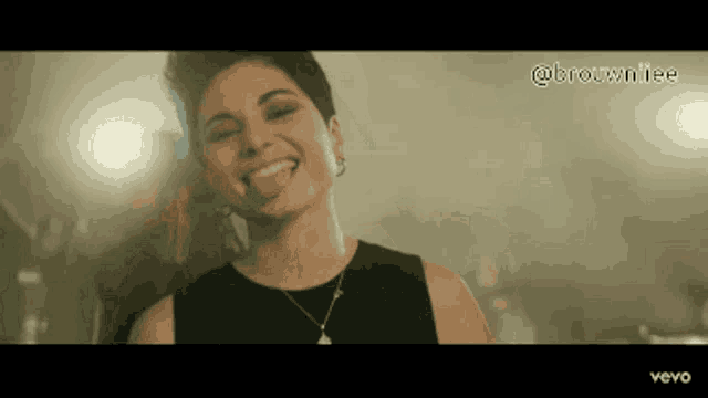 a woman is making a funny face in a video that is sponsored by vevo