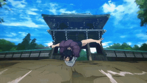 a person is doing a handstand in front of a temple