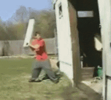 a man in a red shirt is holding a baseball bat