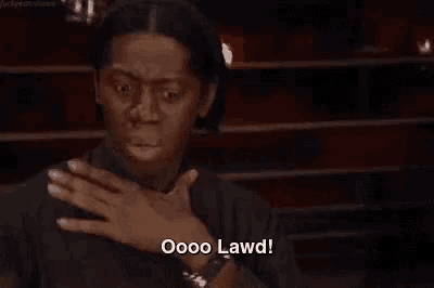 a woman is covering her chest with her hand and saying oooo lawd !