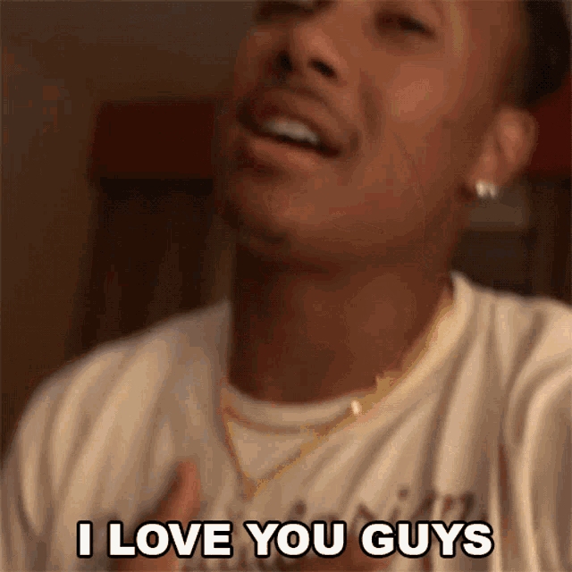 a man says i love you guys with his hand on his chest