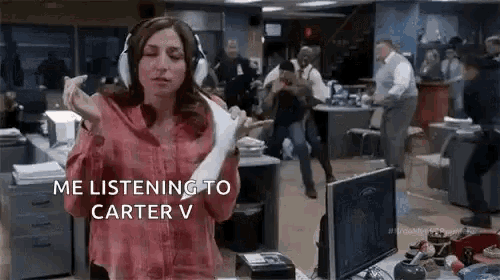 a woman wearing headphones is dancing in an office while holding a piece of paper .