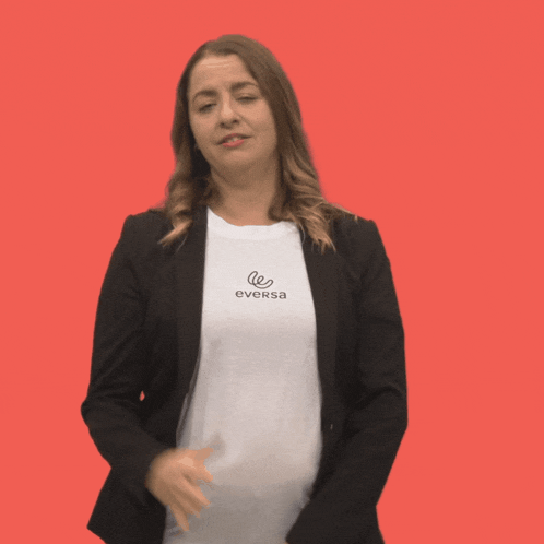 a woman wearing a eversa t-shirt makes a gesture